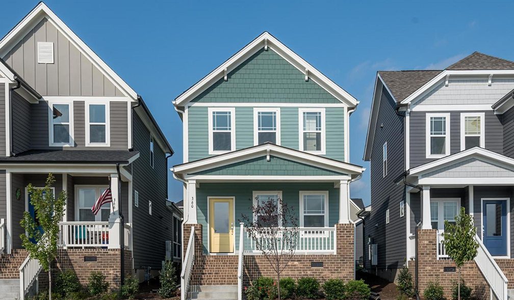 Direct image of newly constructed townhomes with blue sky in the background